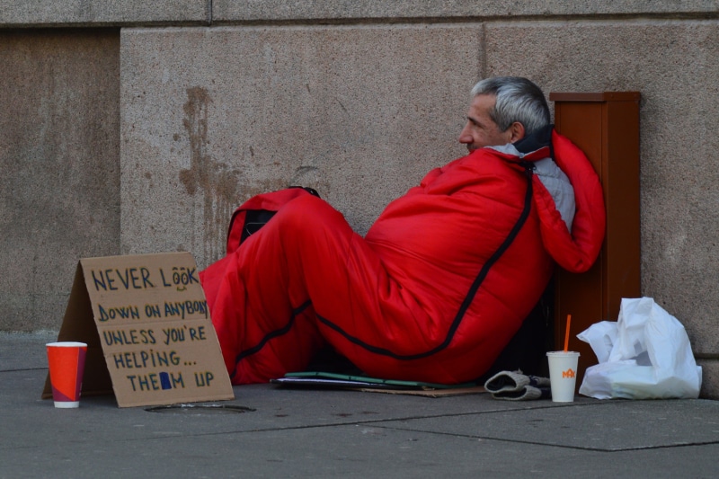 1080P, real people, day, hairstyle, orange, footpath, cardboard, homelessness, orange clothes, men, communication, sitting, sleeping, text, look down on
