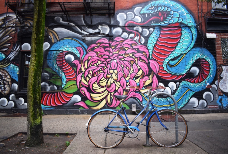tree trunk, building exterior, urban art, color, parked, near, street life, photo, transportation, day, representation, decoration, mural, built structure