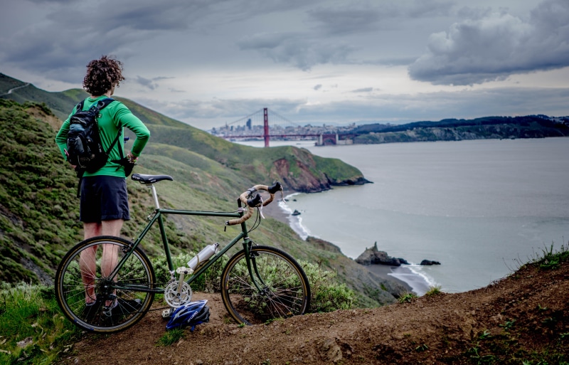 bridge, top, tranquility, mountain, exercise, active, full length, cyclist, bicycle, outdoors, cliff, sport, water, rear view, mountain bike, transportation