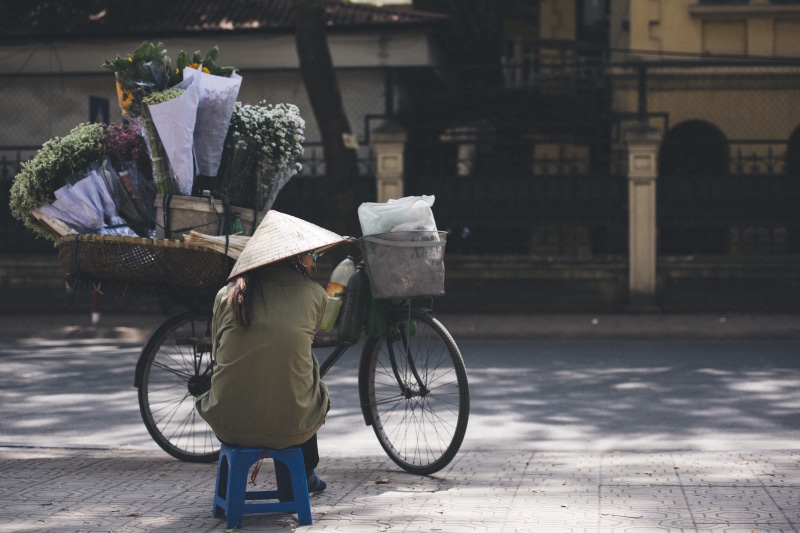 person, land vehicle, outdoors, chair, Flower, day, on the move, city, lady, building exterior, architecture, paper, 5K, one person, built structure, mountain