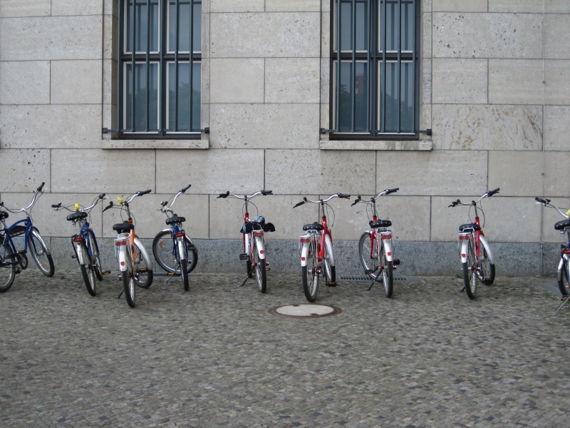 group of people, daytime, cycling, men, bicycle, city Life, window, building exterior, real people, assorted, mode of transportation, day, transportation
