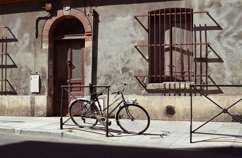 city, windows, sidewalk, 5K, stationary, shadow, building, entrance, outdoors, bicycle, building exterior, mode of transportation, street life, no people