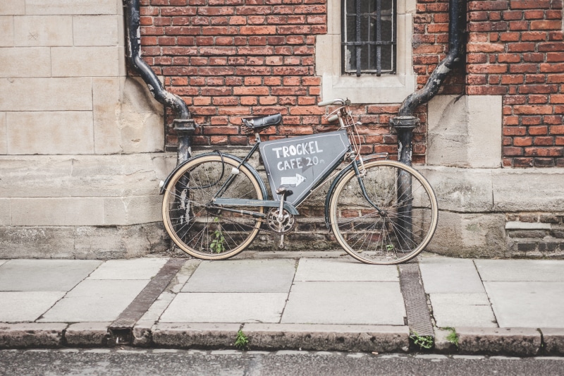 drainpipe, wheel, building exterior, leaning, kerb, stationary, 5K, gray, typography, masonry, built structure, brick, land vehicle, advertising, brown