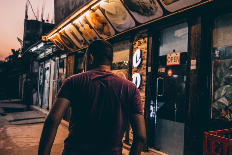 waist up, real people, leisure activity, mood, city, coffee, rear view, storefront, punk, incidental people, one person, three quarter length, cinematic