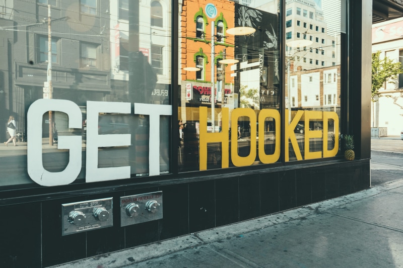 window, information, fruit, downtown, store, tree, communication, type, pineapple, no people, yellow, urban, street, city, transparent, building, text