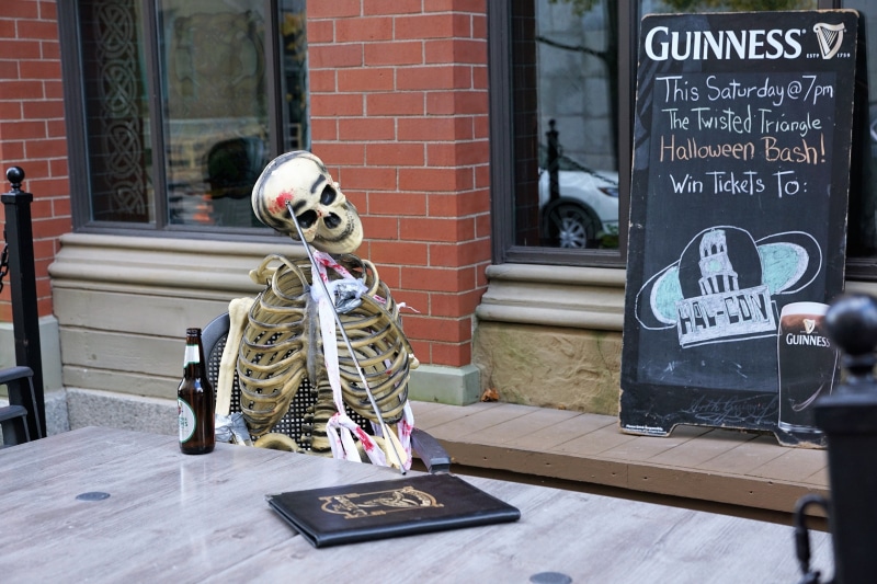 bar, board, outdoors, city, storefront, rip, festival, canada, map, human representation, pub, dead, halloween, death, western script, brick wall, brick
