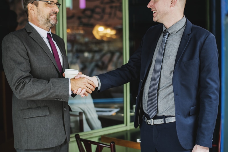 people, shake, communication, window, two, storefront, mature adult, near, business finance and industry, person, corporate business, standing, meeting