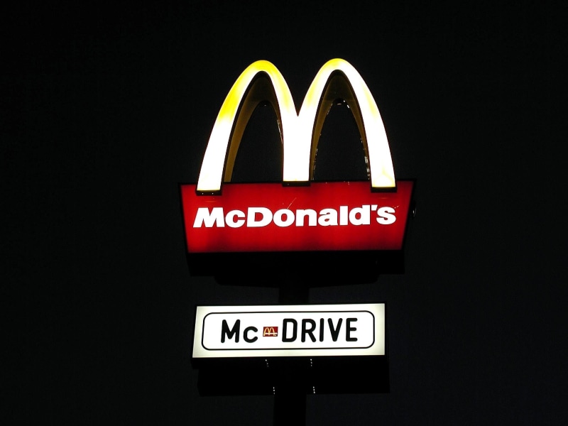 sign, single word, information, lighting equipment, illuminated, communication, black background, donalds, message, mc, no people, signage, glowing, information sign