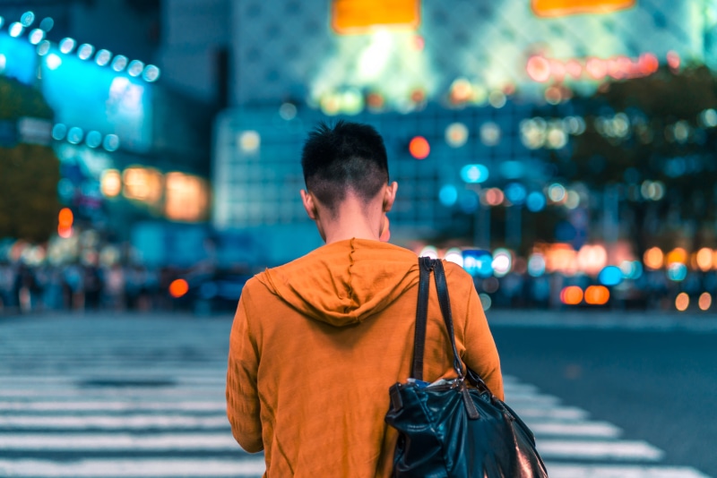 roadside, bag, guy, standing, man, orange, city, lifestyles, real people, girl, japan, one person, illuminated, candid, architecture, woman, fashion, waist up