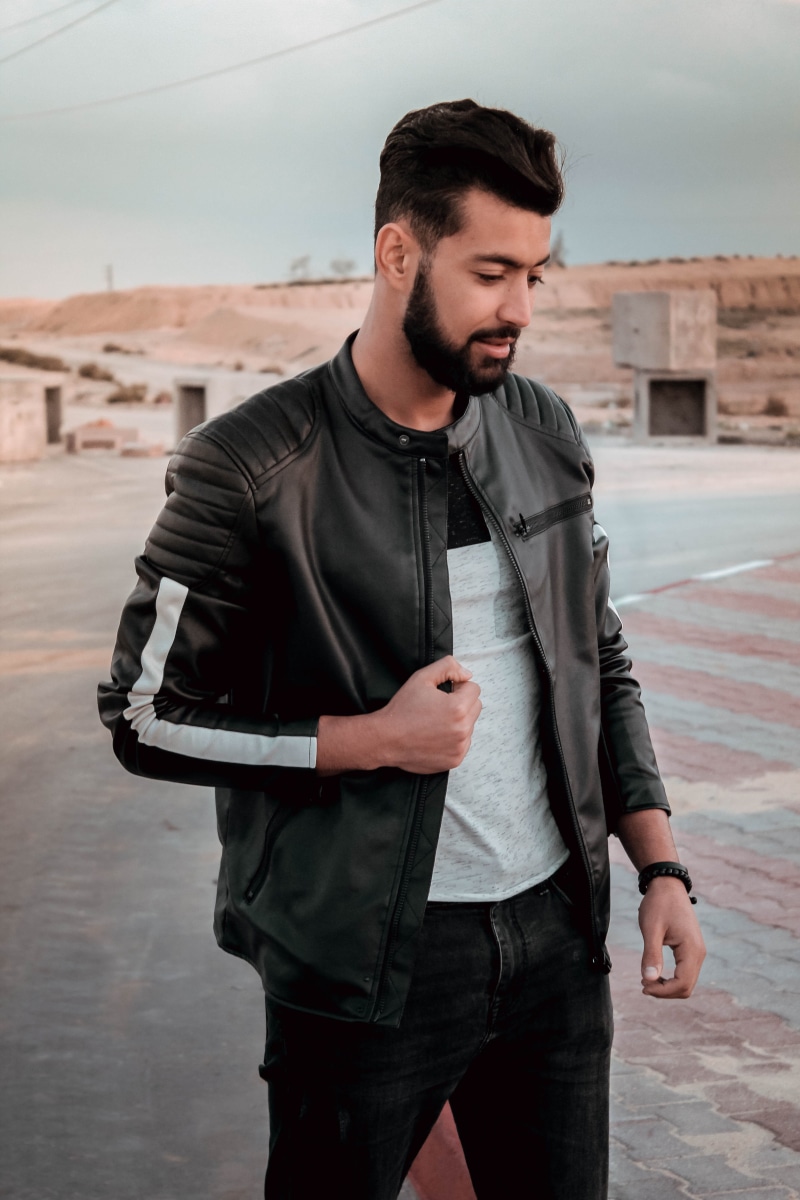 apparel, outdoors, sleeve, three quarter length, face, standing, looking, black, jacket, man, person, human, coat, young men, leather, young adult, architecture