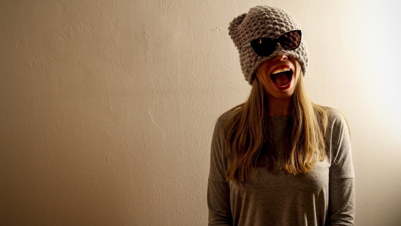 indoors, hairstyle, wall - building feature, facial expression, standing, s, teenager, open mouth, mouth open, brown, print, lifestyles, fun, covering face