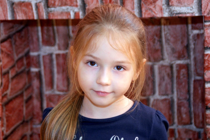 brick, childhood, little, hair, girl, one person, kid, emotion, human face, innocence, close-up, 4K, adorable, day, eye, headshot, smiling, casual clothing