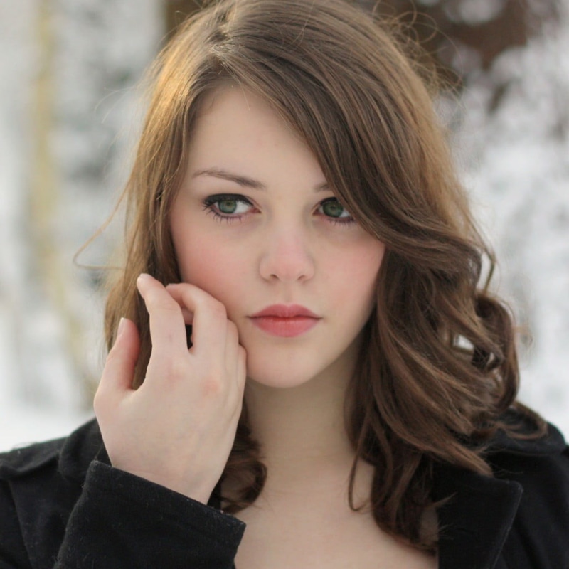 portrait, green eyes, young adult, focus, hand, looking at camera, shallow, contemplation, black, human face, close-up, hairstyle, human body part, black coat