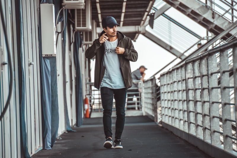 outdoors, casual clothing, adult, music, one person, human, lifestyles, urban, new look, pants, shoe, pedestrian, man, neighborhood, standing, city, overcoat