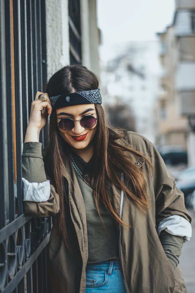 outdoors, one person, hairstyle, architecture, face, scarf, woman, glasses, photo, lifestyles, metal, beautiful woman, costume, black, overcoat, accessories