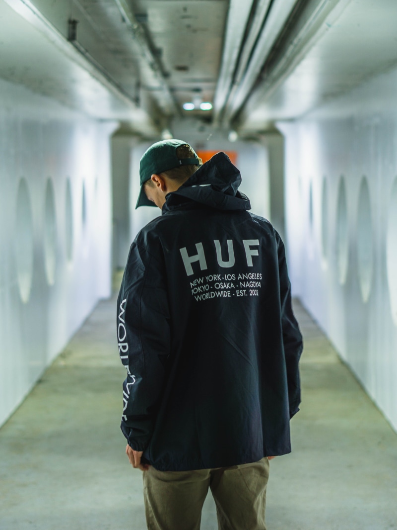 subway, building, sleeve, focus on foreground, arcade, text, coat, apparel, human, person, warm clothing, pants, people, casual clothing, overcoat, portrait