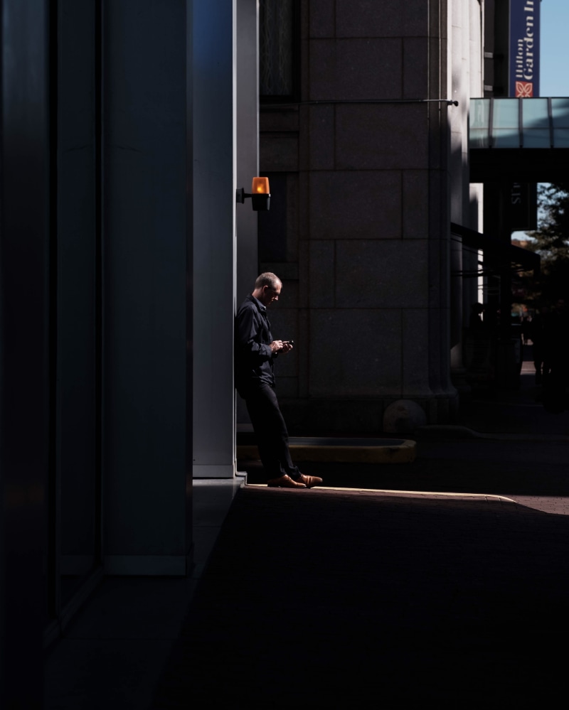 standing, entrance, man, walking, urban, men, outdoors, lifestyles, building, dark, built structure, wall lamp, town, 4K, near, light, clothing, building exterior
