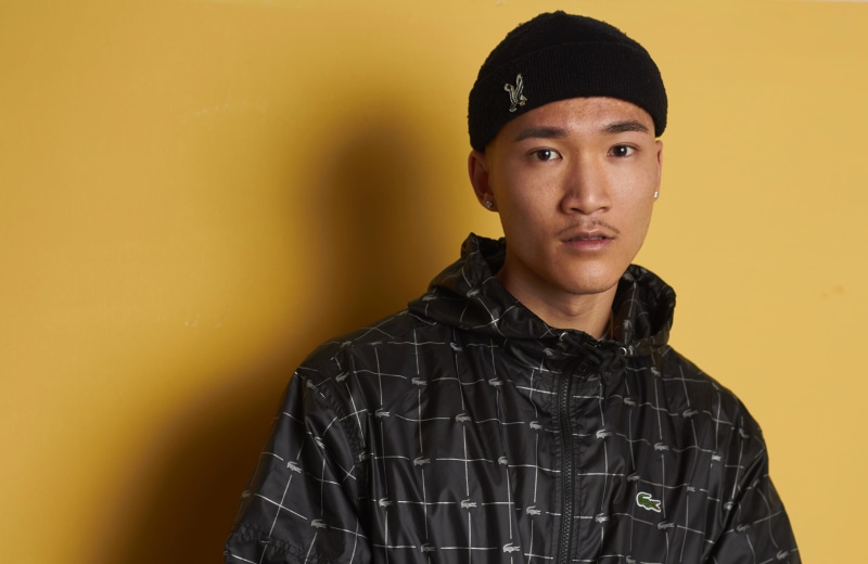 yellow background, standing, baseball cap, headshot, clothing, wall, adolescence, hardhat, lifestyles, man, yellow, face, young adult, portrait, indoors