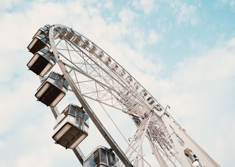 fairground, arts culture and entertainment, metal, outdoors, no people, tall - high, money, electric fan, construction crane, carousel, clothing, architecture