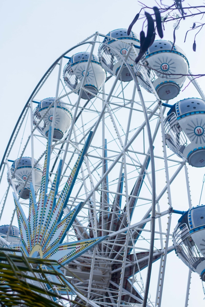 outdoors, sky, machine, sleeve, day, architecture, enjoyment, clear sky, vehicle, amusement park, clothing, theme park, transportation, spoke, nature, ferris wheel