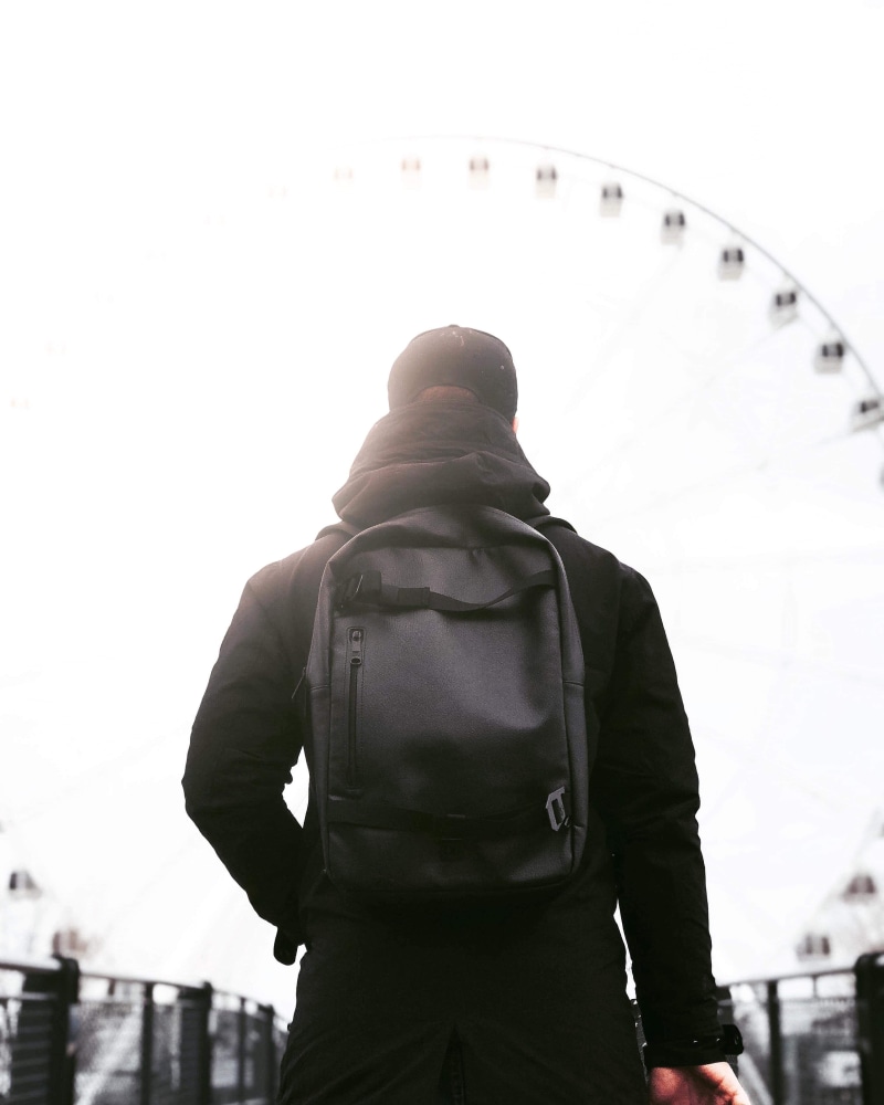 warm clothing, rear view, amusement park, apparel, strap, lifestyles, men, human, sleeve, bag, spoke, standing, amusement park ride, outdoors, machine