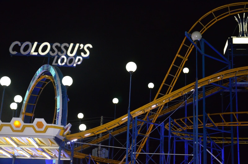 apparel, built structure, overcoat, clothing, night, illuminated, circle, low angle view, metal, arts culture and entertainment, fun, ferris wheel, highway