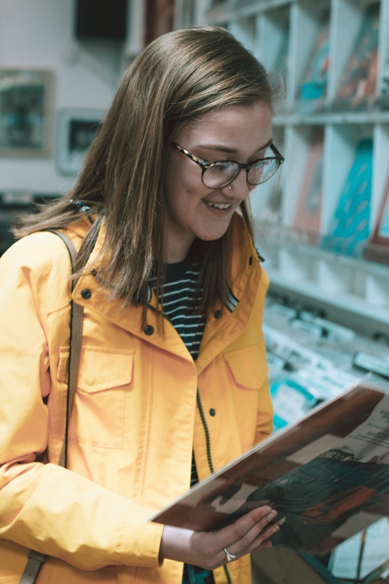 portrait, record store, fashion, young adult, model, smart, buy, hairstyle, real people, eyeglasses, one person, lifestyles, yellow, 5K, holding, trendy