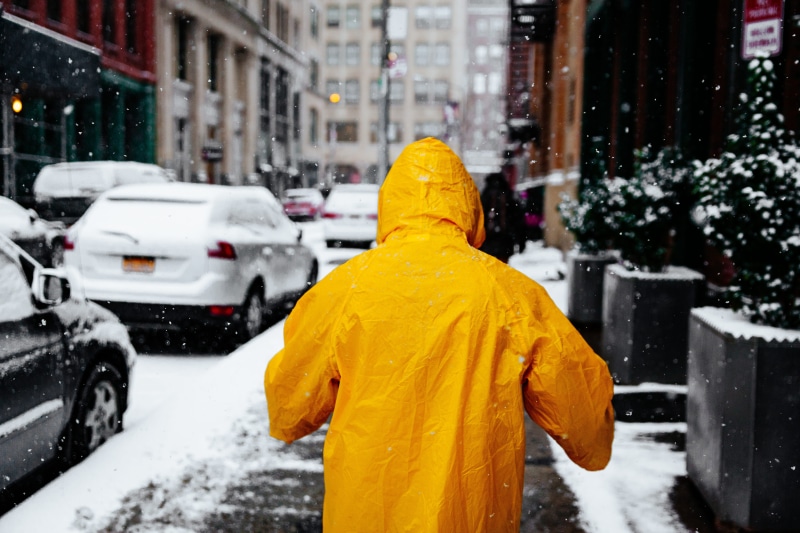 clothing, walking, city, car, street, raincoat, transportation, outdoors, wearing, extreme weather, motor vehicle, built structure, land vehicle, day, 5K