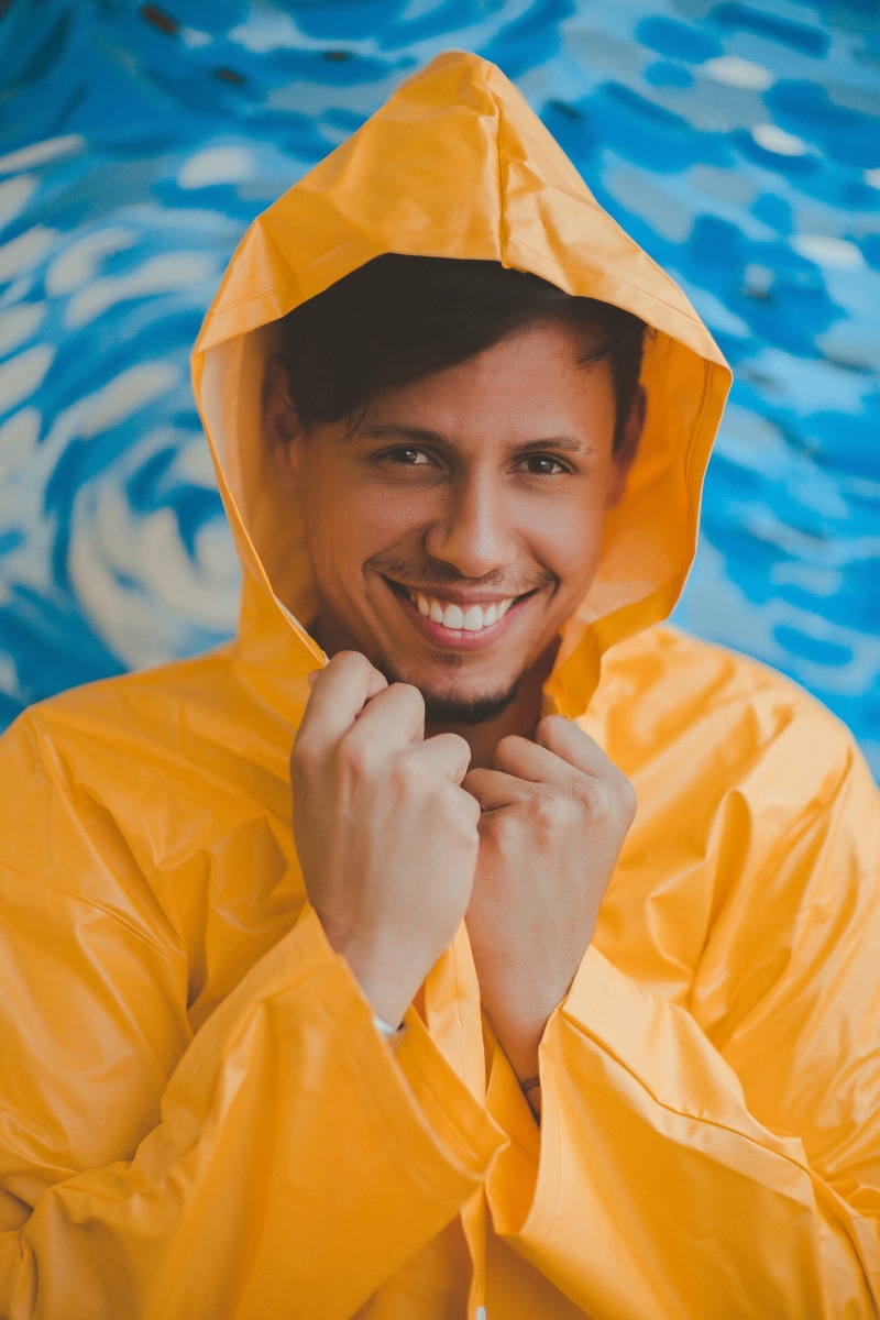 real people, portrait, male, pool, waist up, 5K, raincoat, one person, emotion, lifestyles, hands, swimming pool, smile, fine-looking, casual clothing