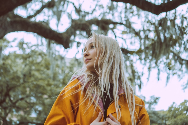 young adult, leisure activity, woman, focus on foreground, day, apparel, wearing, women, nature, plant, coat, lemon, lab coat, sweater, lifestyles, long hair