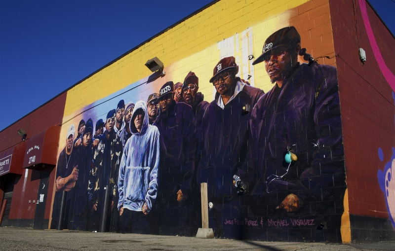 coat, women, photo, face, built structure, raincoat, lifestyles, mural, day, painting, apparel, large group of people, fire, real people, wall, human, graffiti