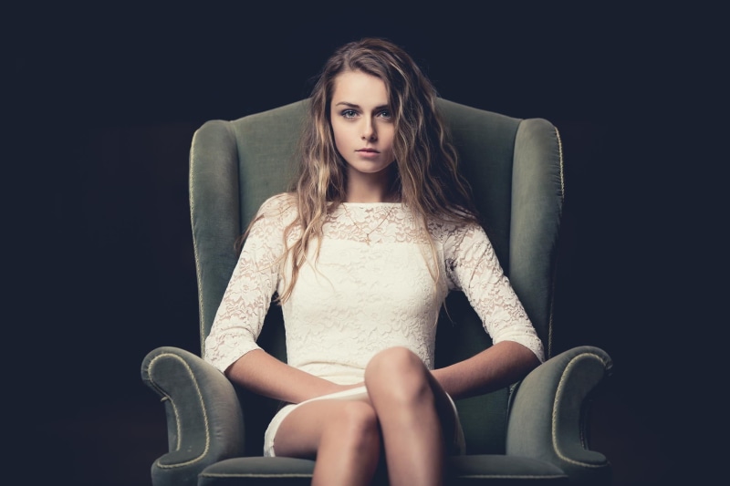 looking at camera, beauty, illusion, dress, white, casual clothing, contemplation, black background, 1080P, woman, chair, floral, neckline, gray, leisure activity