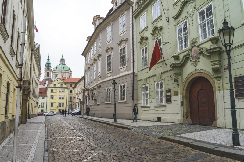 flag, direction, city, real people, footpath, building, built structure, near, incidental people, day, sidewalk, history, the way forward, the past, front