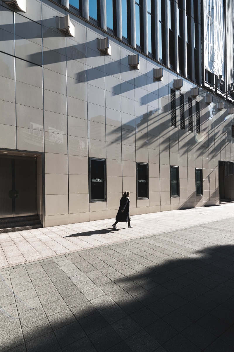 shadow, rear view, near, one person, person, pavement, built structure, long, rise, building, beside, black, building exterior, leisure activity, dress