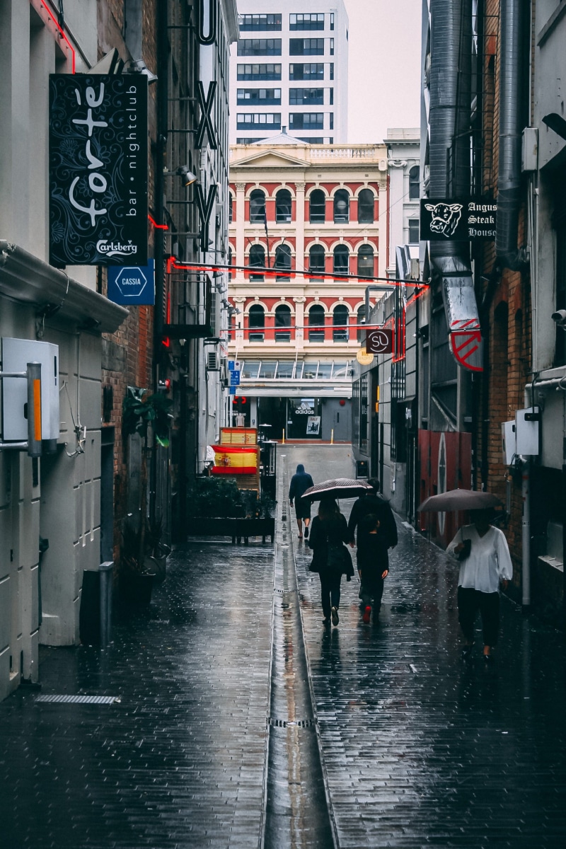 rainy season, men, walking, beside, water, wet, holding, 1080P, people, buildings, day, narrow, city life, group of people, city, umbrella, architecture