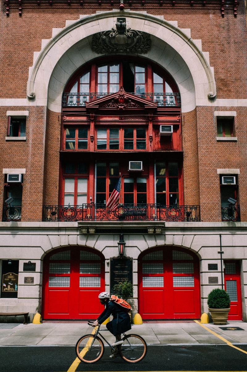 building exterior, sidewalk, canal, helmet, arch, street, one person, built structure, person, city, red, cyclist, backpack, near, travel, traditional design