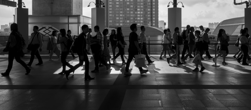 footwear, leisure activity, shoe, rush hour, transportation, city, people, day, black and white, shadow, real people, road, apparel, human, urban, building
