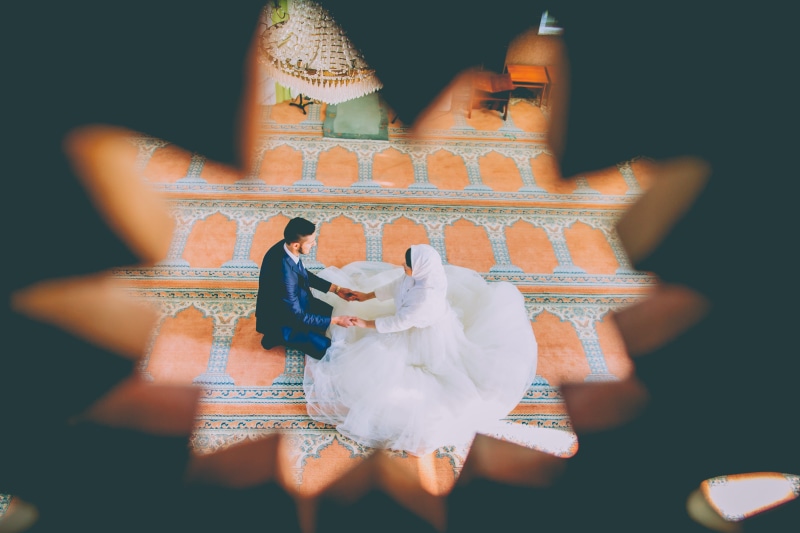 real people, wedding gown, robe, religion, sunlight, couple, adult, wall - building feature, clothing, female, human representation, floor, groom, day