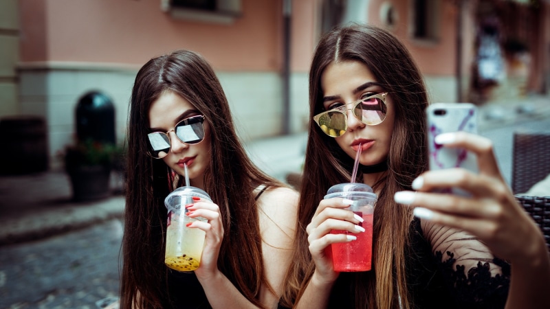 hair, sunglasses, drink, people, technology, hairstyle, wireless technology, refreshment, portrait, teenager, fashion, smiling, glass, two women, happiness