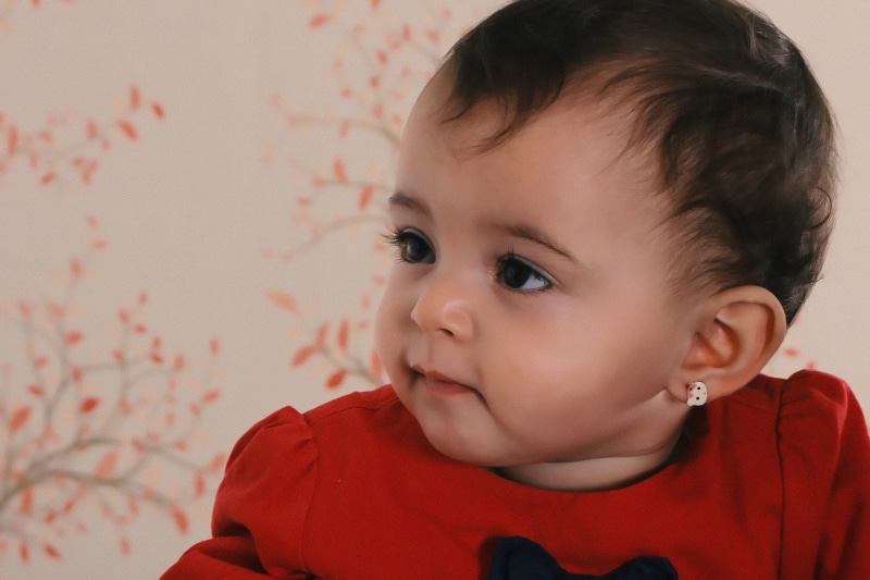 child, human face, looking, wear, indoors, headshot, brown hair, person, wearing, innocence, girl, room, little, smile, black, surface, floral, men, toddler