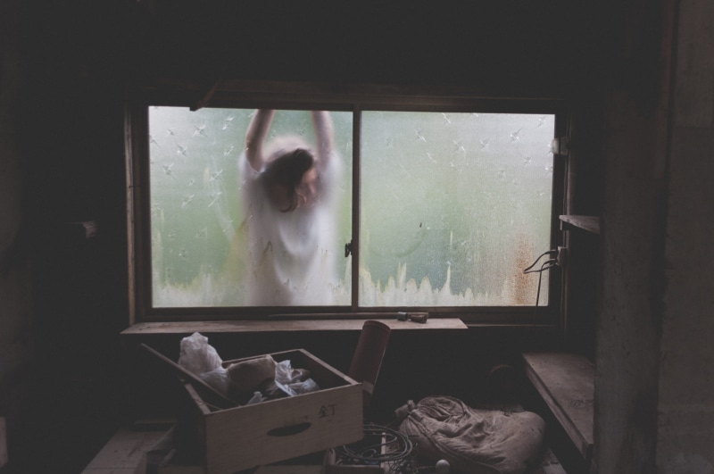 standing, light, home interior, three quarter length, messy, box, day, woman, glass, lifestyles, reflection, panel, one Person, leaning, people, transparent