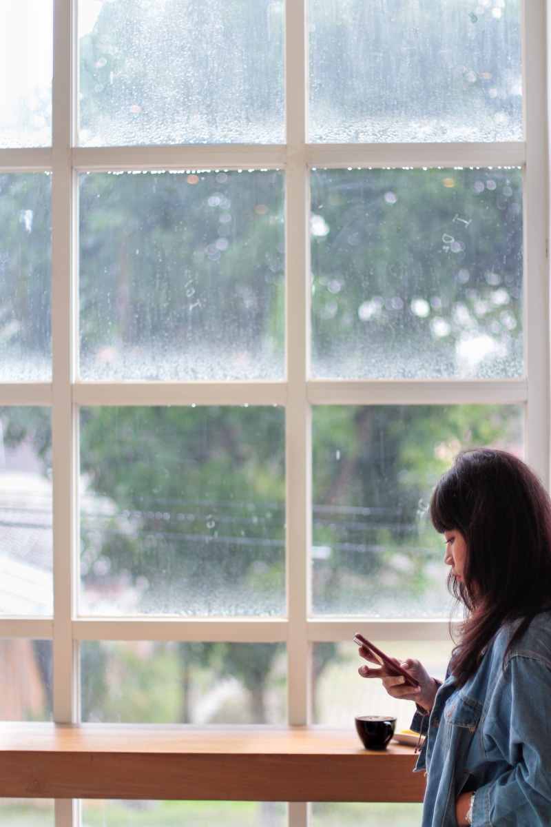 side view, hairstyle, office, window, jacket, wearing, communication, indoors, glass - material, transparent, adult, iphone, wall, glass items, summer