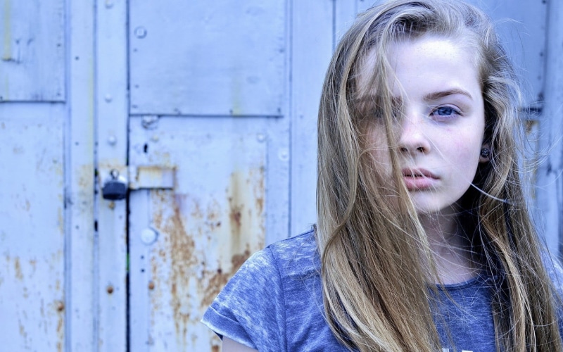 contemplation, teenager, cap, hairstyle, beautiful woman, door, standing, top, young adult, long hair, gray, real people, portrait, beside, looking away