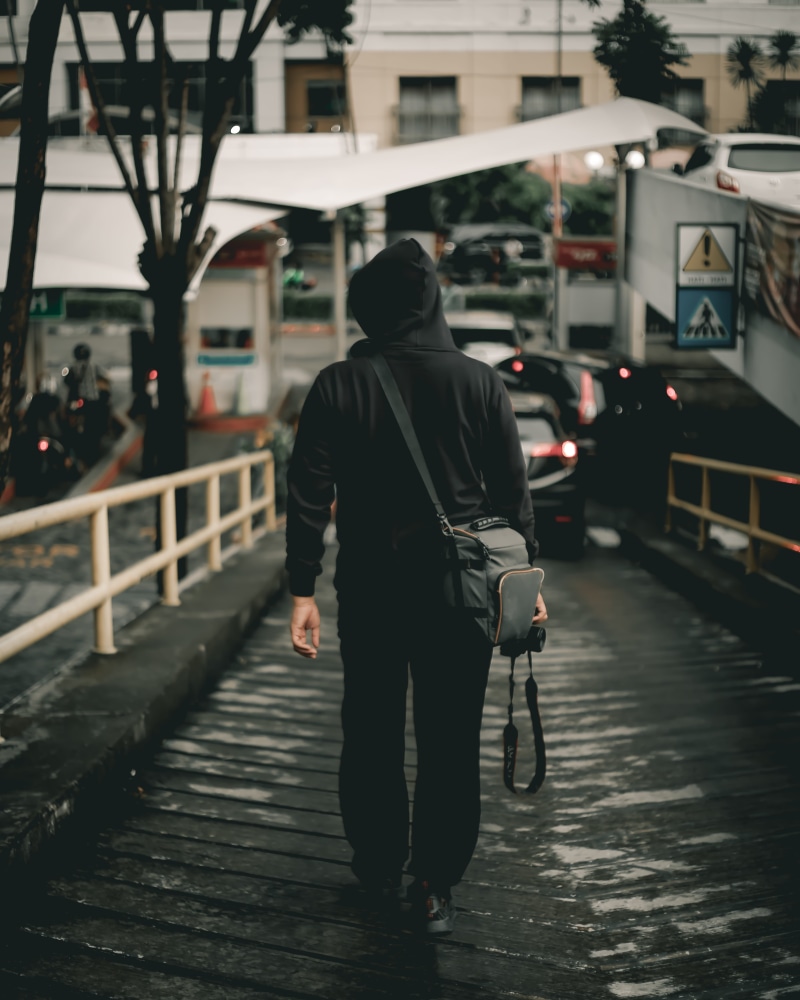 5K, dslr, focus on foreground, lifestyles, street, mode of transportation, back, city life, road, rails, outdoors, beside, real people, walking, architecture
