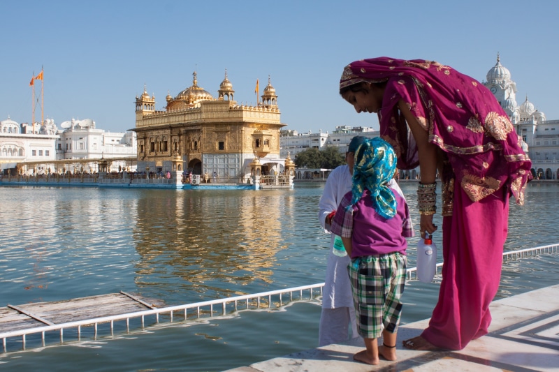 outdoors, water, amritsar, standing, golden temple, real people, body, india, 2K, traditional clothing, one person, women, clothing, amristar, built structure