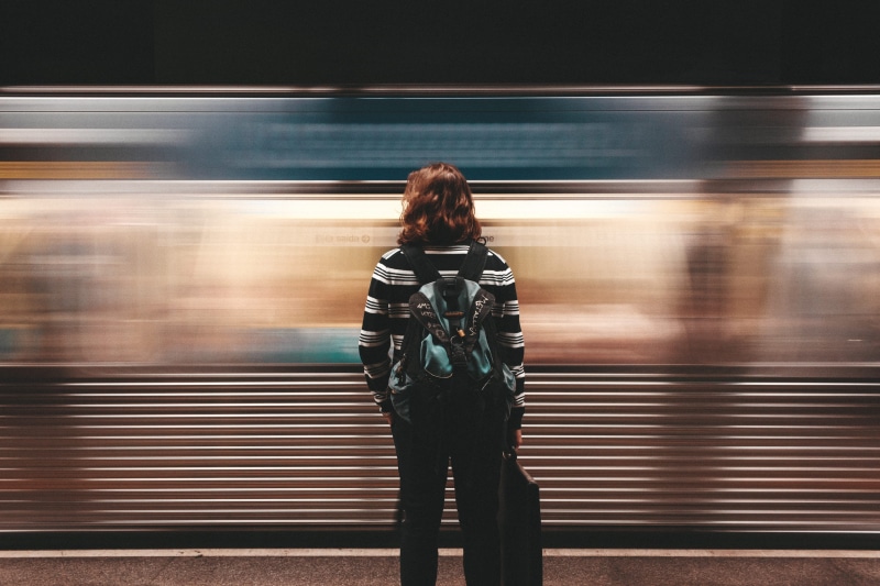 outdoors, hairstyle, city Life, speed, mode of transportation, commuter, person, motion, backpack, train - vehicle, rush Hour, walking, rear view, rail transportation
