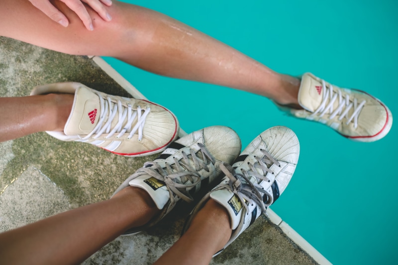 one person, high angle view, shoelace, day, limb, aqua, women, wet, human hand, low section, mlw photography, person, lifestyles, swimming pool, human body part