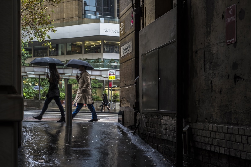 rain, building exterior, nature, walking, 5K, architecture, building, bicycle, woman, two, built structure, lane, footpath, weather, black, water, walk
