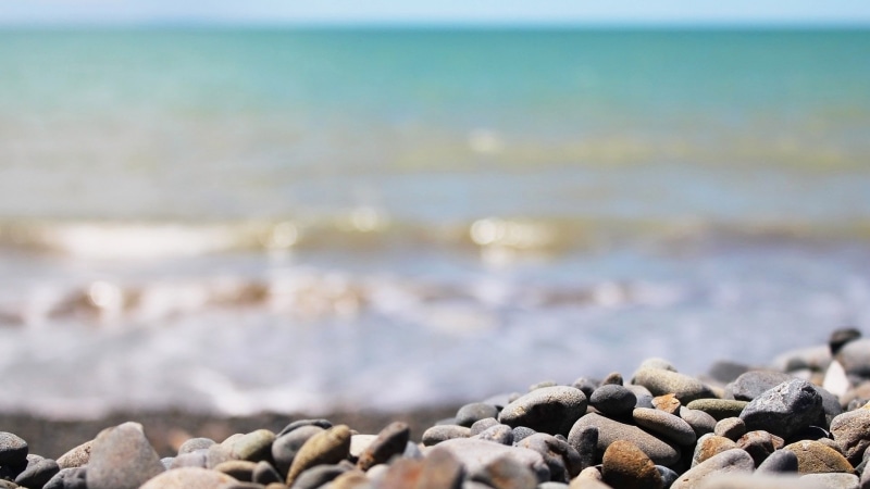 beach, wave, sun, sky, surface level, landscape, sunset, land, calm, lake, holiday, scenics - nature, beauty in nature, tranquil, coast, pebble, sunny
