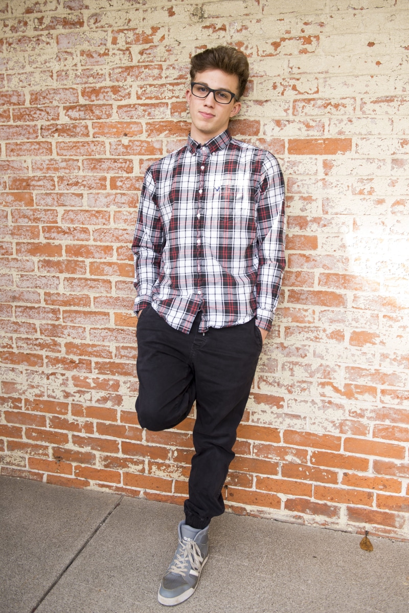 brick, looking at camera, wall, fine-looking, real people, shirt, jeans, day, wearing, one person, dress, style, red, pants, cool, leisure activity, wall - building feature